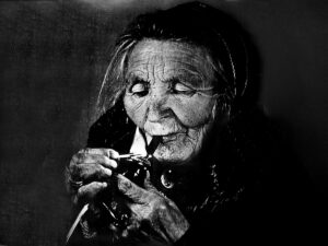 Eldre kvinne røyker pipe