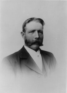 portrett av mann med dress og bart